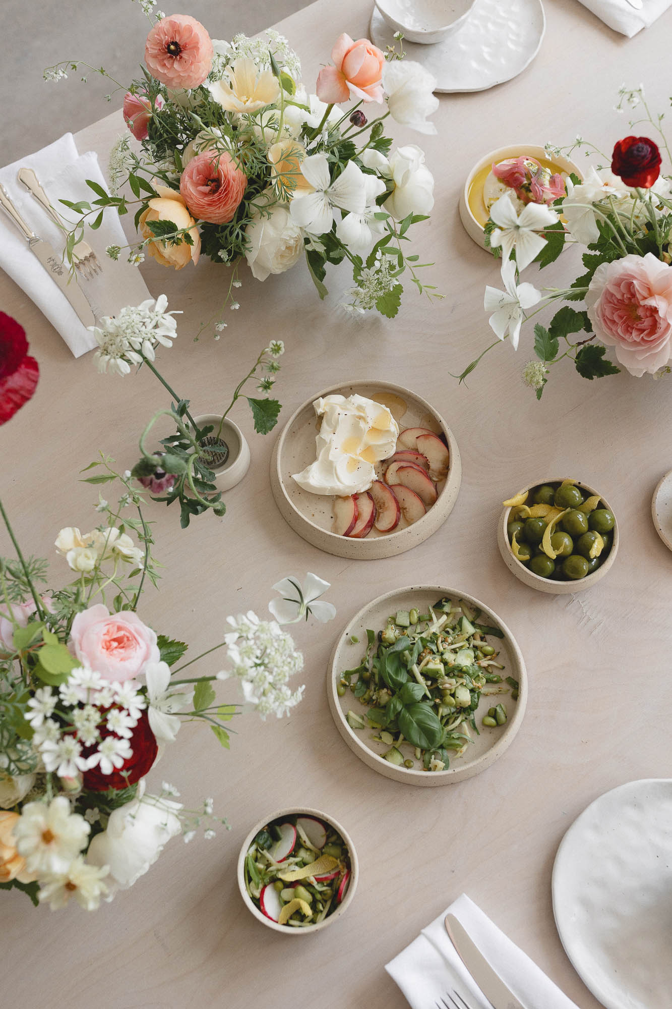 Colourful tablescape of food and flowers Photo ©Daisy Price Photography